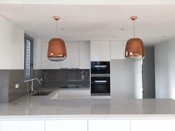 Fantastic copper pendant lights above kitchen counter